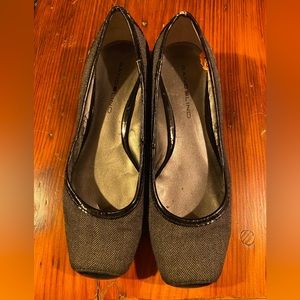 Bandolino flats. Have a lot of life left. Some nicks in the black patent edging.